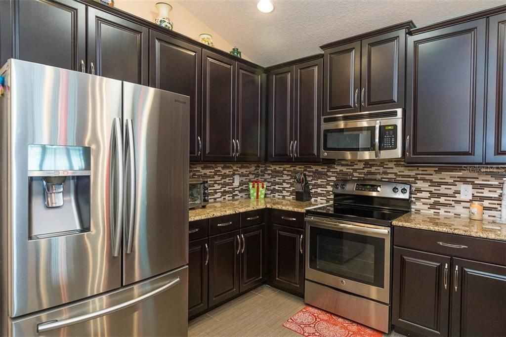 Kitchen with freezer on the bottom stainless steel refrigeratior and Stainless Steel Microwave and Stove