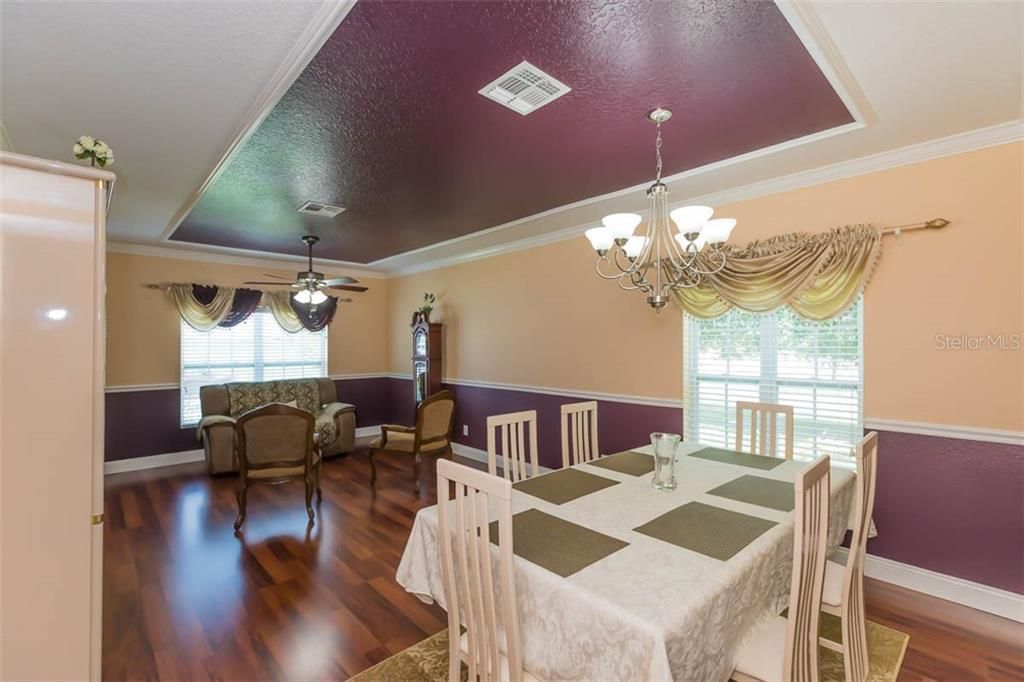 Formal dining room with window looking out to corner yard