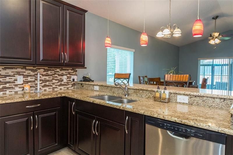 Kitchen with granite countertops and 42" Cabinets with crown molding and Tile backsplash