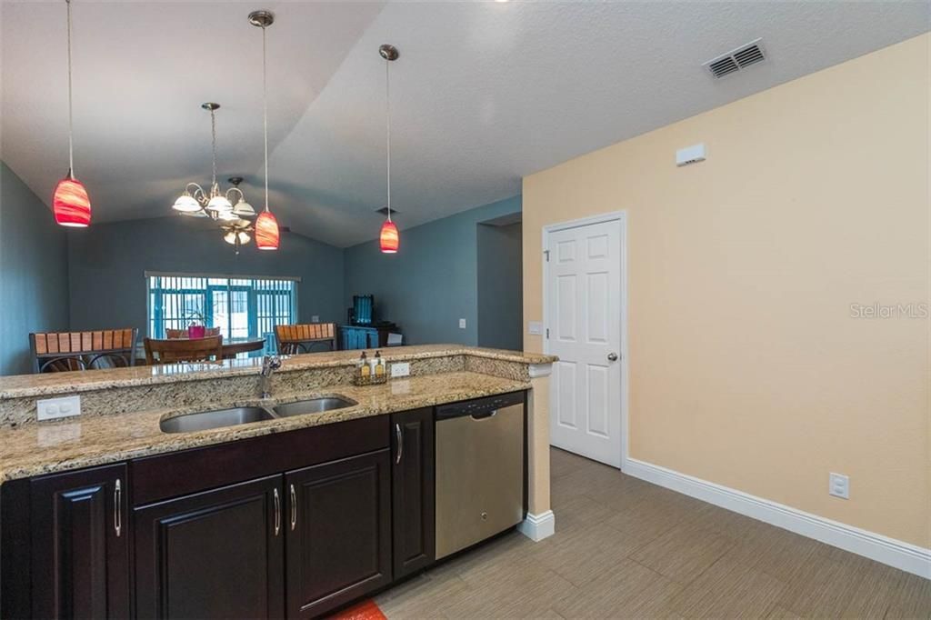 Kitchen Breakfast Bar with Pendant lighting and stainless steel dishwasher