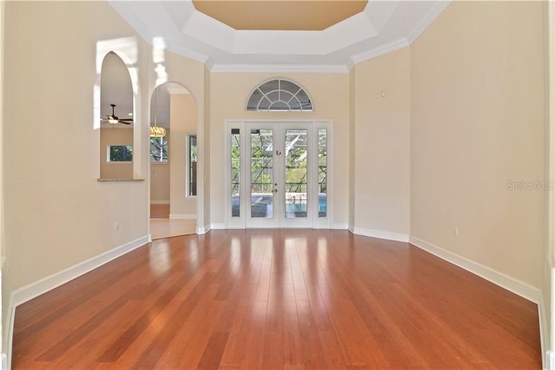 Wood Floors. Trey Ceiling. French Doors. Open to the Kitchen.