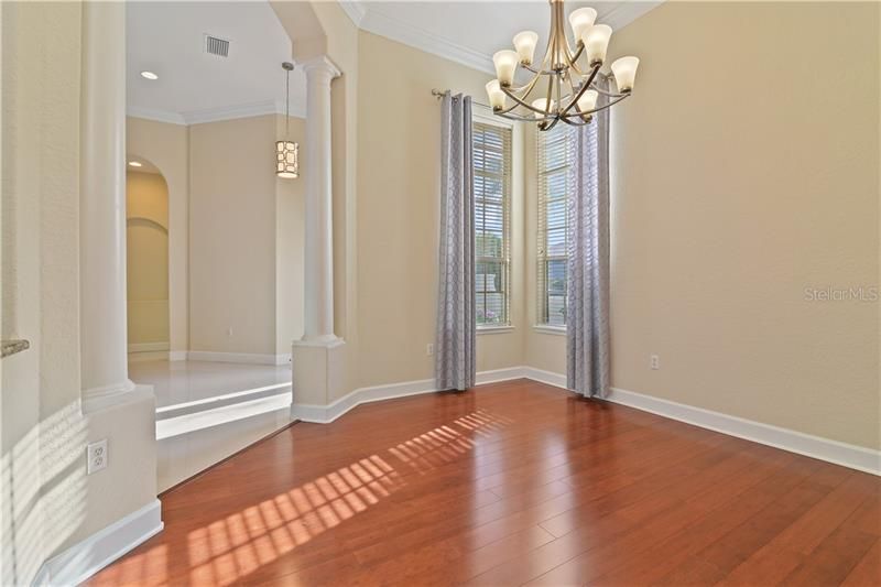 Wood Floors. Updated Light Fixture. Crown molding. Natural Light. Open to the Kitchen.