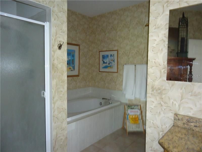 View of shower stall and tub of master bath,