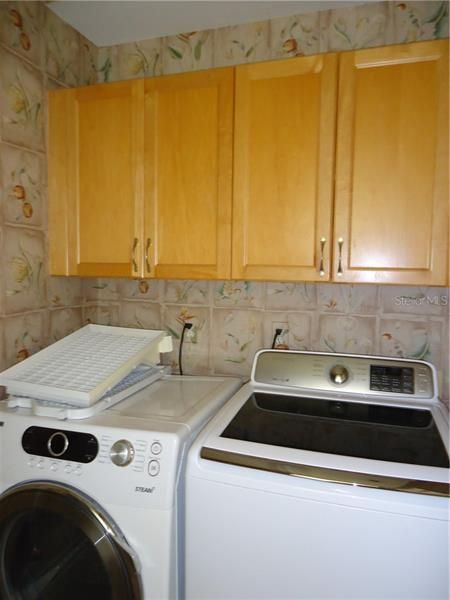 Laundry room with maple cabinets.