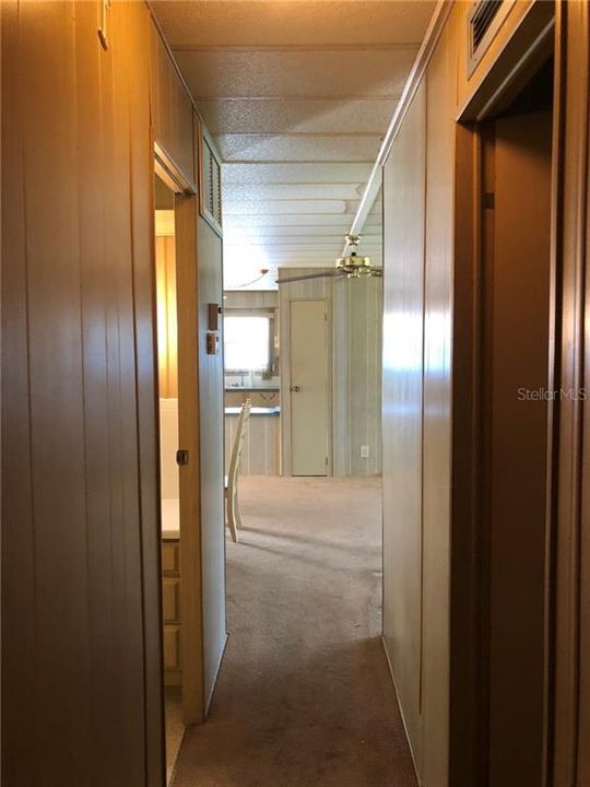 Hallway leading to Half Bath/Laundry & Bedrooms