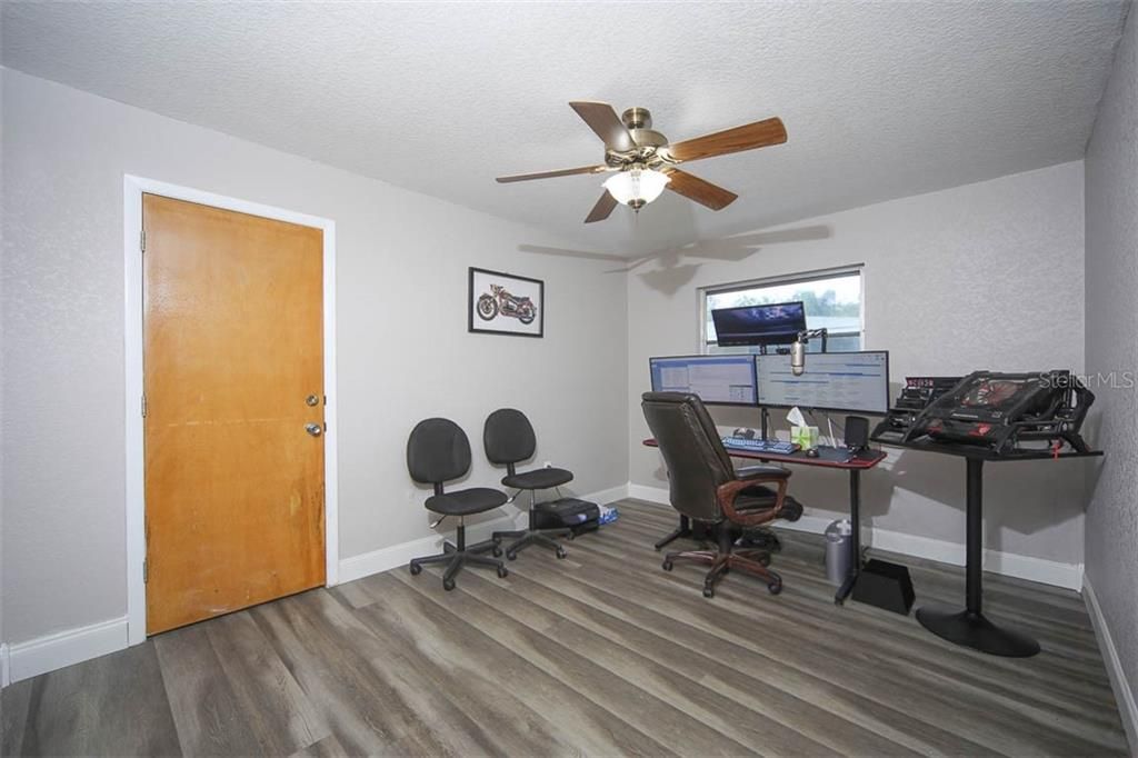 GUEST BEDROOM WITH WALK-IN CLOSET AND SEPARATE DOOR OUT TO GARAGE