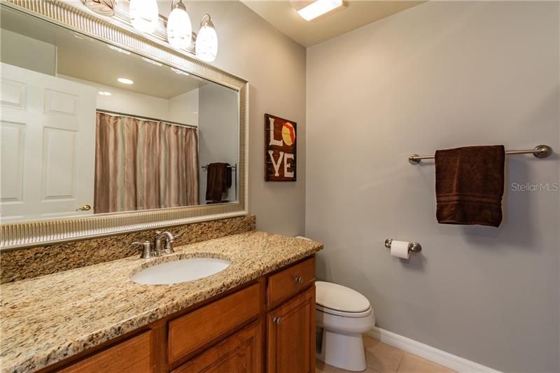 Guest Bathroom featuring Upgraded Lighting Fixture and Granite Countertop!