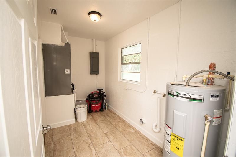 Laundry room with new air handler, and hot water heater