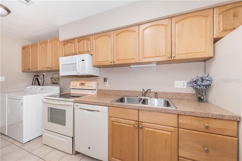 Maple wood cabinets, handy washer and dryer inside unit