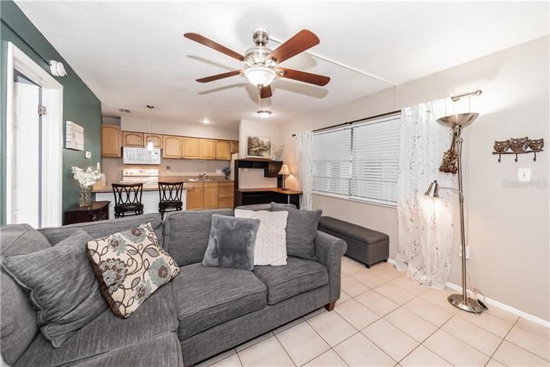 Open floor plan, ceiling fan, tile floors, natural lighting