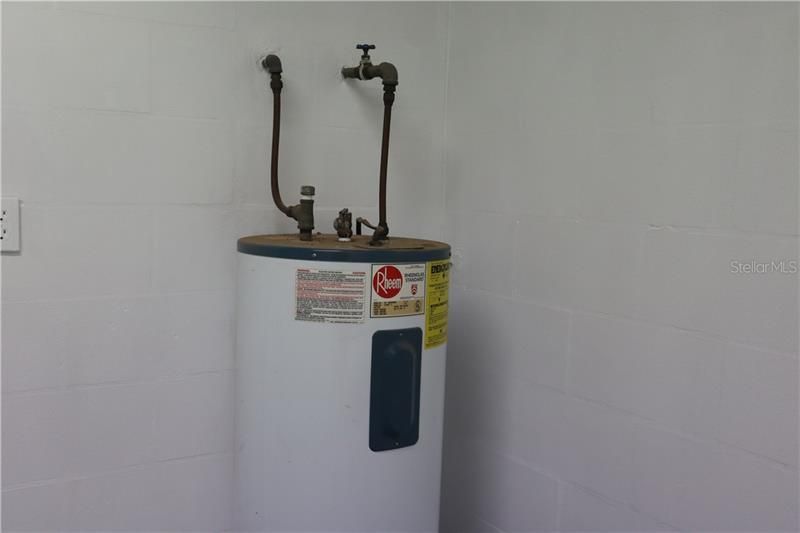 Hot water heater inside the laundry room.