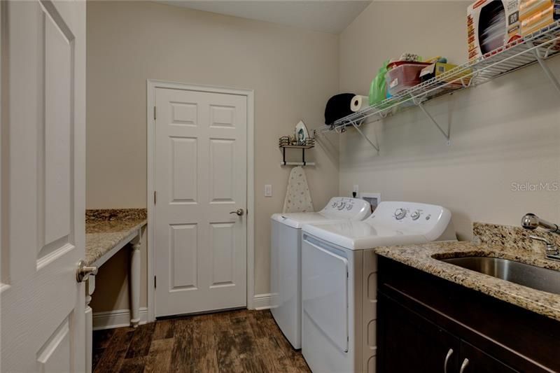 Laundry room with upgraded utility sink and granite counter top.