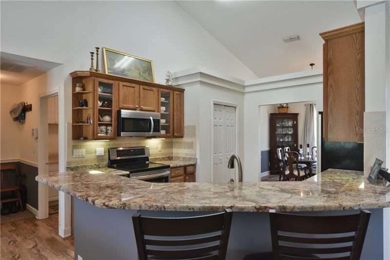 Beautiful Kitchen with a Farmhouse sink ,wood cabs, pantry, SS appliances & breakfast bar.