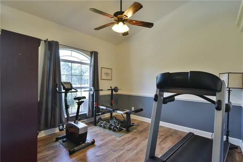 Office off the front entry foyer is being used as an exercise room