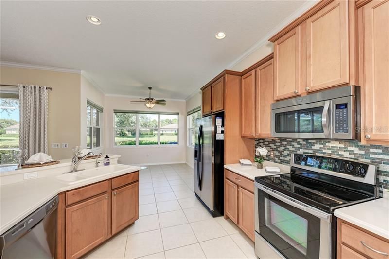 The spacious kitchen ahs stainless steel appliances and a beautiful backsplash