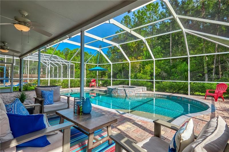 Enjoy RESORT STYLE Outdoor Living by splashing into this FANTASTIC Oversized SALT-WATER pool with Spillover SPA & SUN SHELF or enjoy sitting poolside on the SPACIOUS lanai (39’x8’)!!!