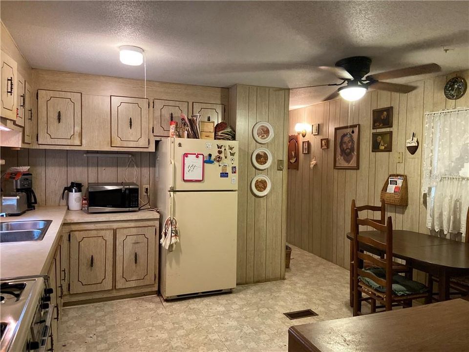 Kitchen and dining room view. Hallway with Laundry leads to second bed & bath. Also back screen porch.