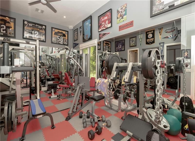 located just off the pool area, the gym is perfect for the serious fitness fanatic or anyone who just wants to tone up.  With a closet, full bathroom and stand-alone access, it would also make a great in-law suite, office with exterior access, craft/art room, or additional bedroom.
