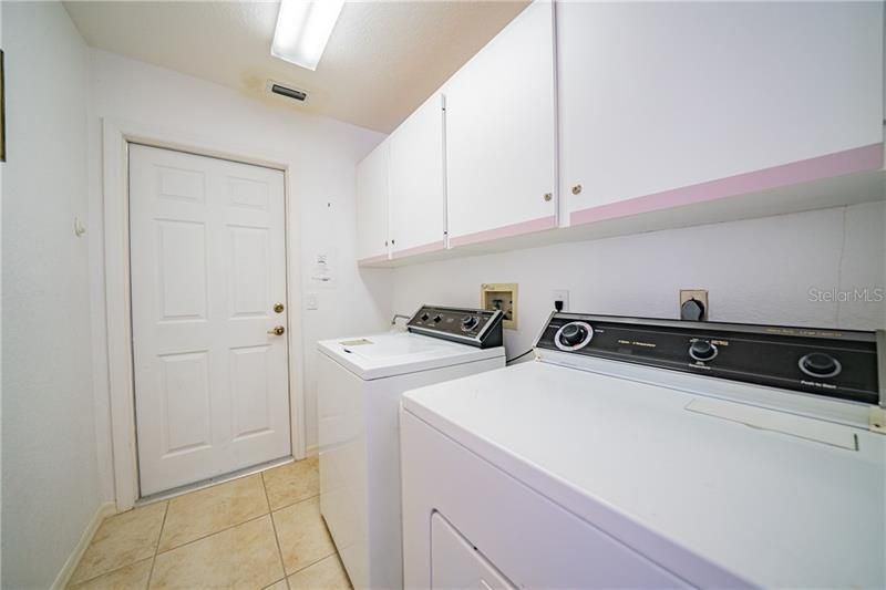 Laundry Room with washer, dryer and cabinets and laundry tub