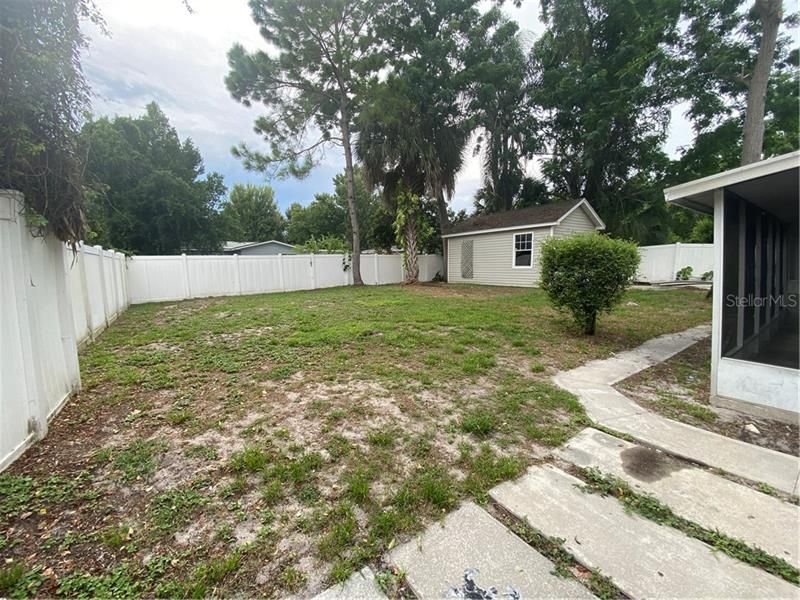 Completely fenced back yard with cement area for easy boat or trailer parking!