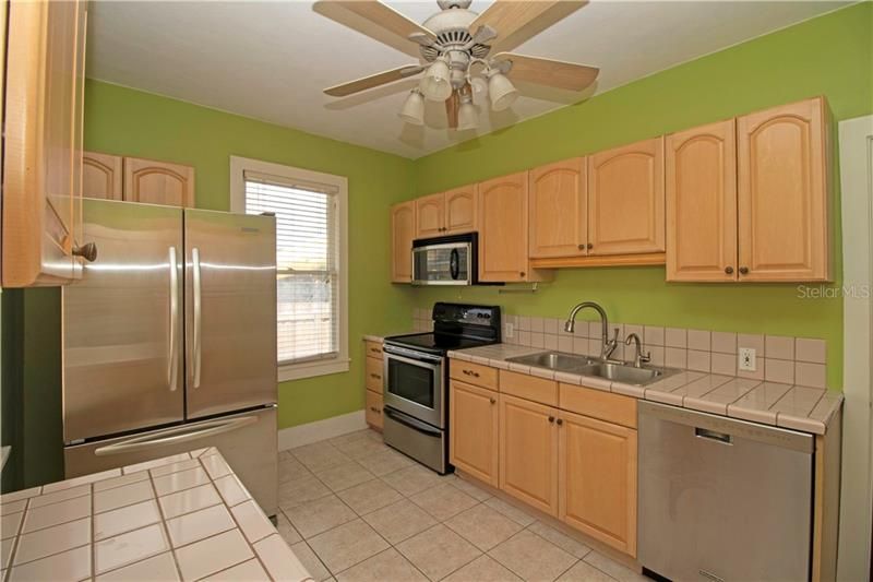 Kitchen with lots of cabinets and stainless steel appliances