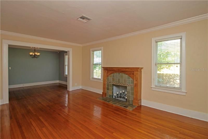 Comfortable living room with natural light and crown molding.