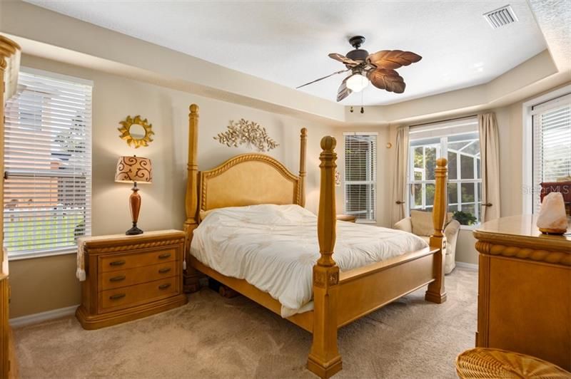 Spacious Master Bedroom has two walk-in closets and access to pool/lanai.