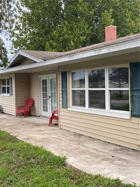 Front of home with concrete sidewalk to second entrance.