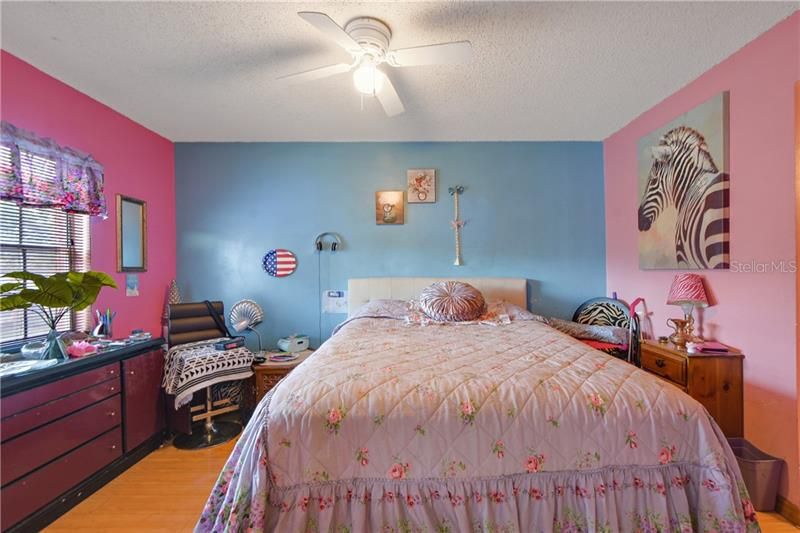 Spacious PRIMARY BEDROOM features pretty WOOD TRIM around the FRENCH DOOR entry, ceiling fan, a WALK IN CLOSET & full bath!