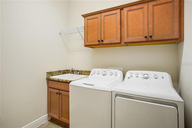 Inside laundry with utility sink and extra cabinet space