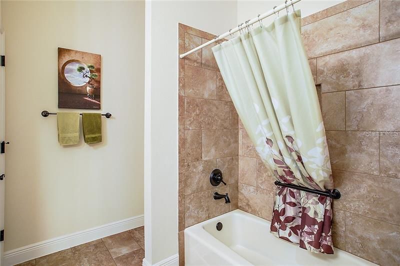 Guest bathroom with tub and shower combination
