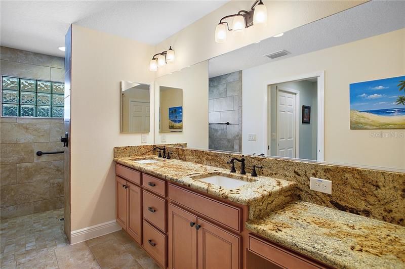 Large en suite with granite countertops and dual sinks