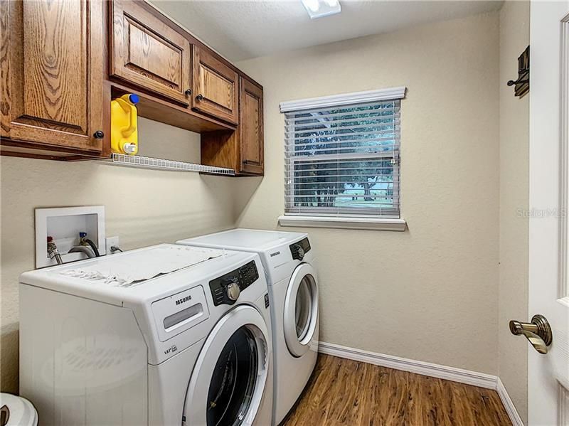 Inside laundry with built in cabinets.