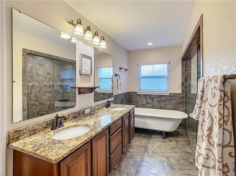The master bath offers double sinks, recessed lighting and a soaking tub.