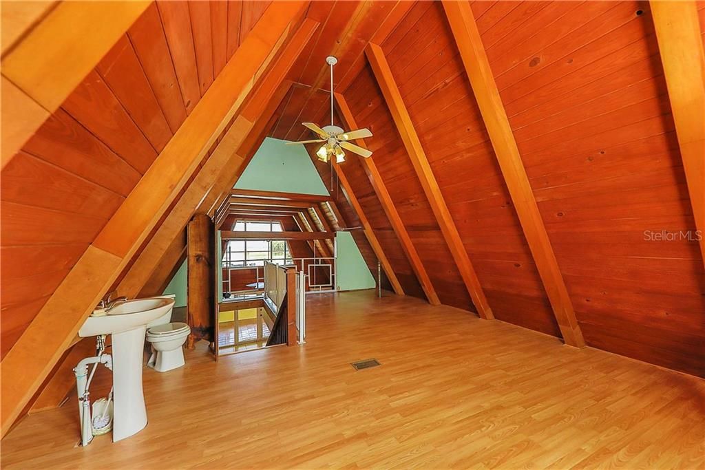 Third bedroom/loft space with sink and toilet.