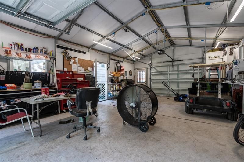 Insulated workshop interior with 220 amp service and roll-up doors on each end.