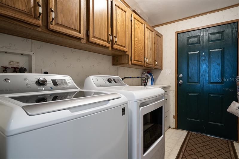 Indoor utility room with an abundance of cabinetry. Washer and dryer do not convey.