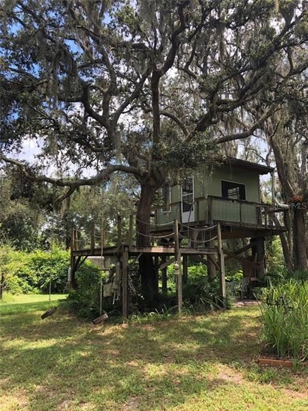 Side view of tree house with additional sitting deck