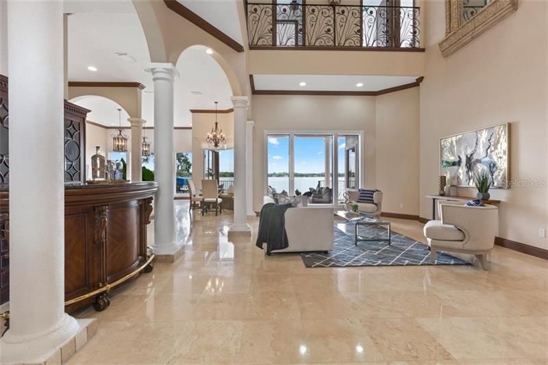 Soaring, open floor plan; glistening marble floor and a bar for the entertainer at heart.