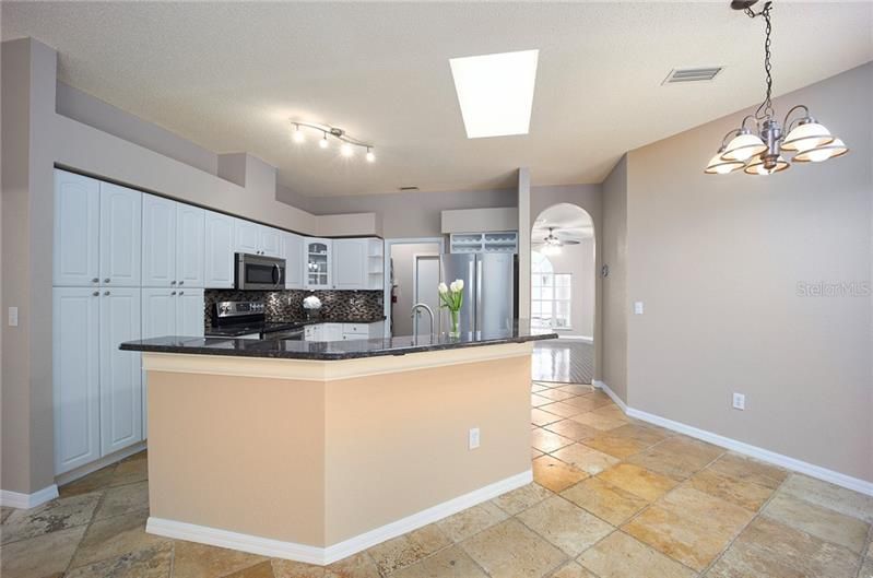 Upgraded kitchen with granite, stainless appliances, wood cabinets & travertine floors! Counter height breakfast bar too!