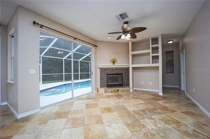 Wood burning fireplace and travertine flooring in the family room!