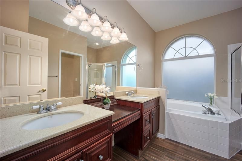 Master bath with his & hers sinks, upgraded cabinets, garden tub and walk in shower!