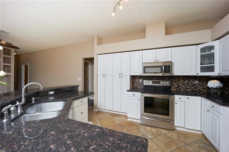 Beautiful granite counter tops and upgraded cabinets with hidden pantry!