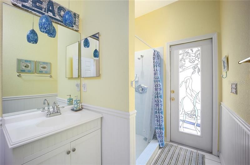 Full bathroom 3, with upgraded vanity & lights and access to the pool area through a custom stained glass door!