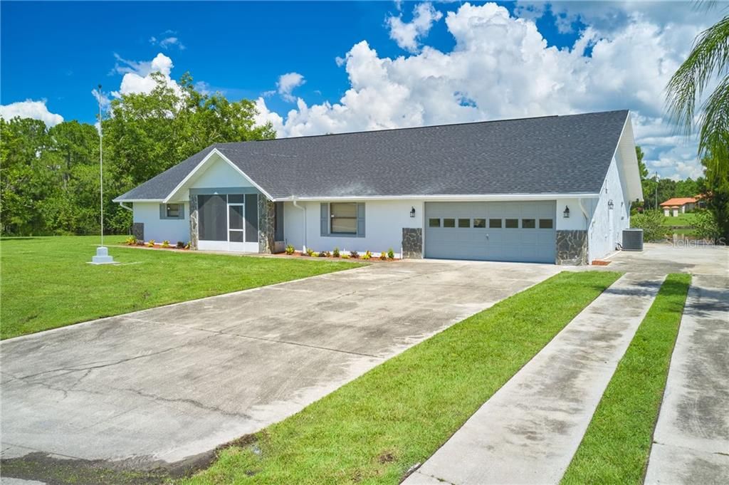 Front exterior.  Lots of parking room!  There is concrete slab on the right side with RV hookups!
