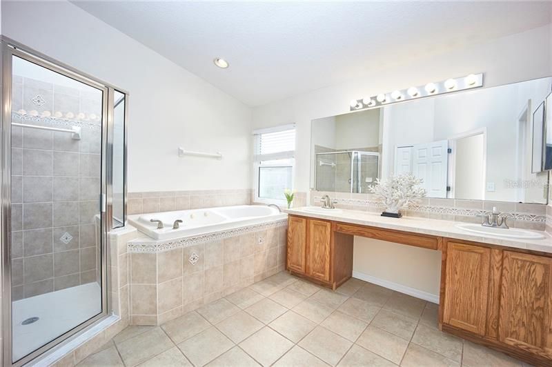 Lovely master bathroom with walk in shower, garden tub, and his & hers sinks!