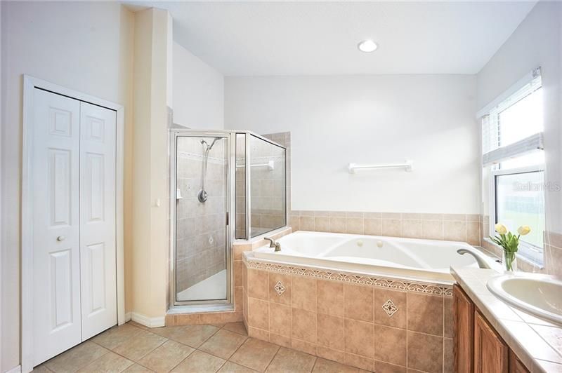 Master bathroom with newly tiled walk in shower, Jacuzzi tub, plus his & hers sinks!