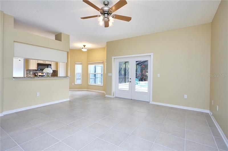 Light and bright family room leads to the kitchen and out to your dream patio and pool area!