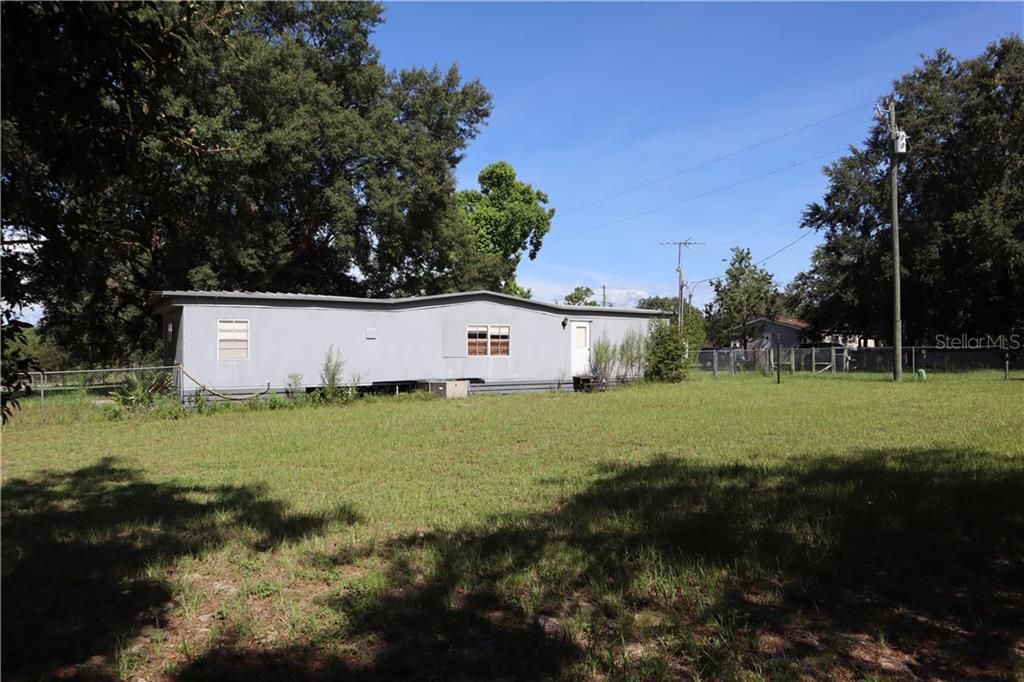 Rear of home in 2nd fenced in portion of the large yard