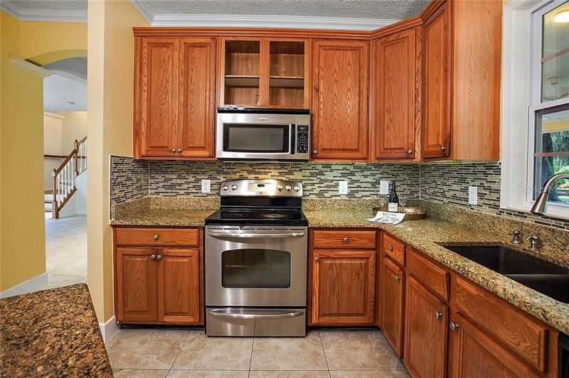 Under cabinet lighting to enhance the glass backsplash and granite counters ~